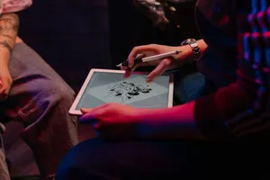 Tattoo artist sketching on a tablet, creating unique digital designs under neon lighting. jigsaw puzzle