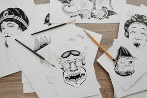 Close-up view of traditional tattoo design illustrations on paper with brushes and pencils. jigsaw puzzle