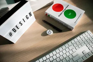 Bright desk setup featuring design book, keyboard, and hashtag lightbox for creativity. jigsaw puzzle