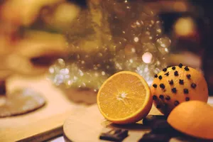 Warm, soothing scene of clove-studded oranges on a wooden table, evoking holiday spirit. jigsaw puzzle