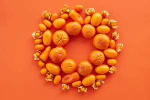 Flat lay of assorted orange fruits and vegetables on a matching background for a colorful display. jigsaw puzzle