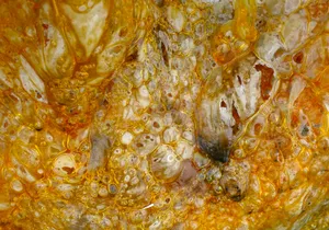 Close-up of an abstract amber-like texture with vibrant orange accents, showcasing intricate details. jigsaw puzzle