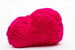 Bright pink yarn ball against a white backdrop, ideal for knitting projects. jigsaw puzzle