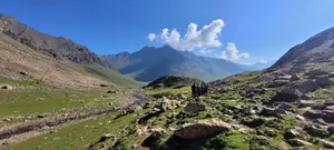 a group of people walking on a rocky path in a valley jigsaw puzzle