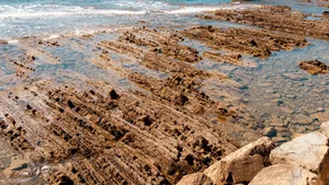 Rippled rock formations at the ocean's edge jigsaw puzzle