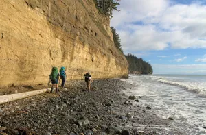 a group of people walking along a rocky beach jigsaw puzzle