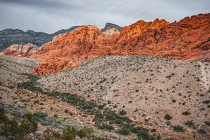 a mountain range with a few trees in the foreground jigsaw puzzle