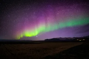 a bright purple and green aurora bore is in the sky jigsaw puzzle