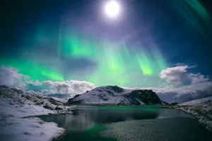 a green and blue aurora bore over a lake jigsaw puzzle