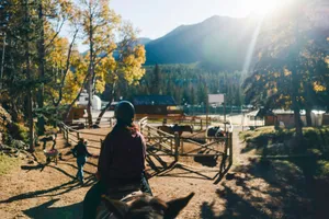 Riding horses through a mountain ranch in autumn. jigsaw puzzle
