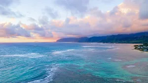 Calm ocean waves near a tropical coastline at sunset jigsaw puzzle