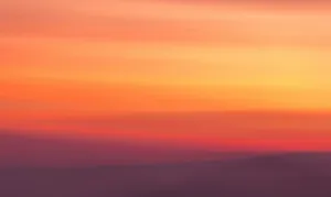 a blurry photo of a sunset with a plane in the foreground jigsaw puzzle