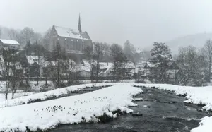 A village with a church during a snowfall jigsaw puzzle