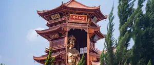 Golden statue within an ornate multi-tiered wooden pagoda. jigsaw puzzle