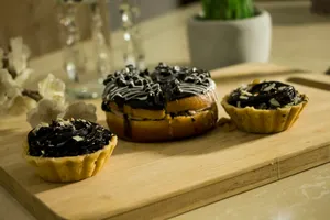 black and white chocolate cupcakes on brown wooden tray jigsaw puzzle