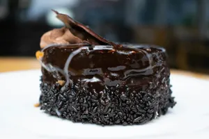 A piece of chocolate cake sitting on top of a white plate jigsaw puzzle