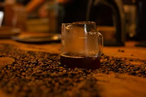 Iced coffee in a glass mug surrounded by roasted beans. jigsaw puzzle