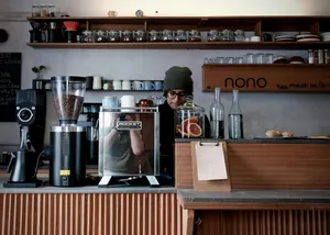 Barista working behind a coffee counter with equipment. jigsaw puzzle