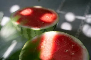 two slices of watermelon sitting on top of a table jigsaw puzzle