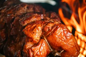 A large piece of meat sitting on top of a grill jigsaw puzzle