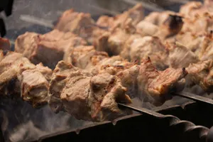 Meat skewers cooking over an open flame jigsaw puzzle