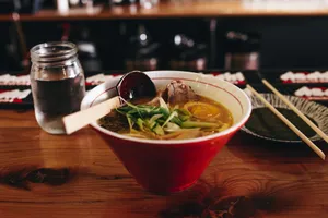 soup with vegetable beside chopsticks and glass of water jigsaw puzzle