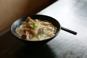 noodles served on black bowl on table jigsaw puzzle
