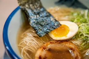 white soup with brown meat on blue ceramic bowl jigsaw puzzle