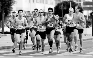 grayscale photo of people performing marathon jigsaw puzzle