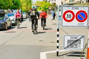Cyclists ride on a street with traffic signs. jigsaw puzzle