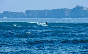 man surfing at the ocean during day jigsaw puzzle