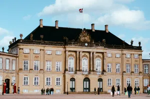 a group of people standing in front of a large building jigsaw puzzle