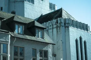 White historic buildings with dark roofs and pointed windows. jigsaw puzzle