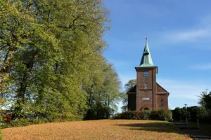 Brick church with green steeple under blue sky jigsaw puzzle