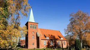 Brick church with orange roof and green steeple. jigsaw puzzle