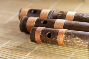 a close up of three wooden pipes on a bamboo mat jigsaw puzzle