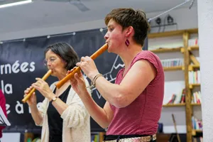 Two women playing wooden flutes indoors. jigsaw puzzle