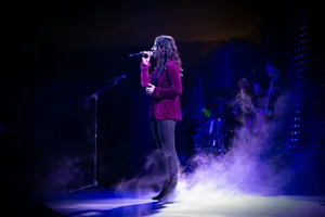 woman singing on stage with purple lights jigsaw puzzle
