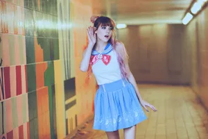 a girl in a blue skirt is standing in a hallway jigsaw puzzle
