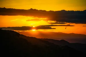 The sun is setting over a mountain range jigsaw puzzle