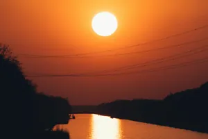 the sun is setting over a body of water jigsaw puzzle