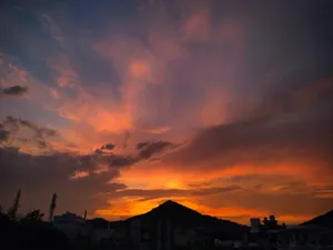a sunset with clouds and buildings in the background jigsaw puzzle