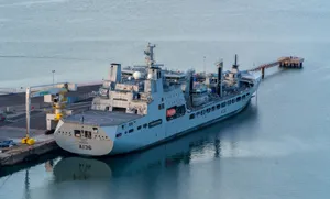 A large boat docked at a dock in the water jigsaw puzzle