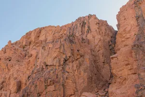 A striking rocky cliff in a desert landscape showcasing erosion and natural beauty. jigsaw puzzle