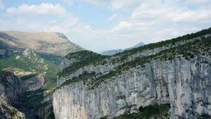 Discover the majestic cliffs and lush greenery in this stunning landscape photo. jigsaw puzzle