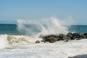 Dynamic ocean waves splashing against a rocky shore. jigsaw puzzle