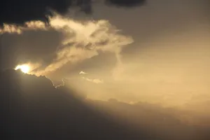 A stunning view of the sky at sunset with dramatic clouds and sun rays breaking through. jigsaw puzzle