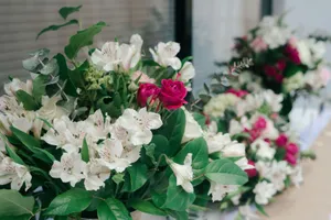A beautiful bouquet of pink roses and white lilies in a lush green arrangement perfect for decoration. jigsaw puzzle