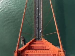 Stunning aerial perspective of the Golden Gate Bridge with vehicles crossing over the water. jigsaw puzzle
