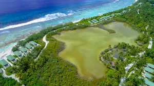 Stunning aerial view showcasing vibrant tropical resort and coastline in Addu City, Maldives. jigsaw puzzle